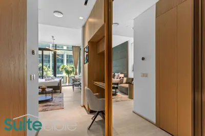 a hallway with a living room and a dining room at Aesthetic Studio with Stunning Pool View in JVC in Dubai