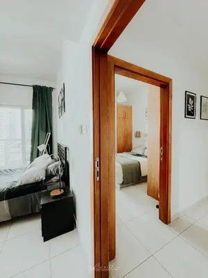 a bedroom with two beds and a door with a mirror at LivWithUs - 2 BR in Marina View Tower B in Dubai