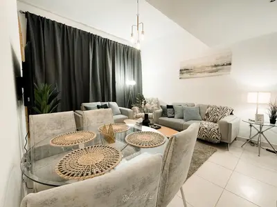 a living room with a table and a couch at LivWithUs - 2 BR in Marina View Tower B in Dubai