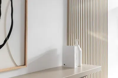 a white vase sitting on a shelf next to a mirror at Modern Studio Apartment JVC in Dubai
