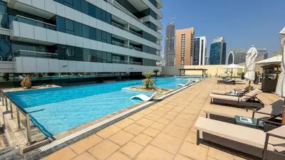 a swimming pool on the side of a building at Central Apartment in Dubai Heart in Dubai