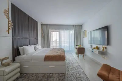 a hotel room with a bed and a television at Central Apartment in Dubai Heart in Dubai