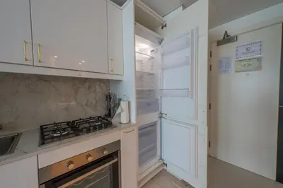 a kitchen with white cabinets and a stove at Central Apartment in Dubai Heart in Dubai
