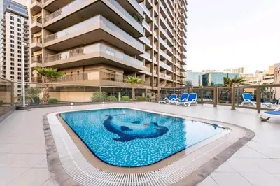 a dolphin swimming in a pool in a building at 1BDR with Burj Khalifa Views in Elite Downtown in Dubai