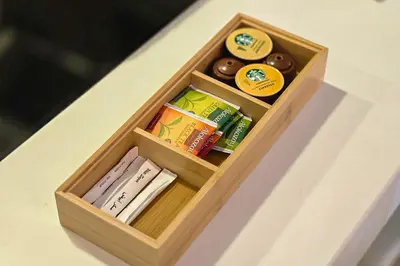 a wooden box filled with donuts on a table at EasyGo - Chic 1BR in Damac Maison in Dubai