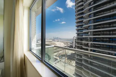 a window with a view of a city from a building at EasyGo - Chic 1BR in Damac Maison in Dubai
