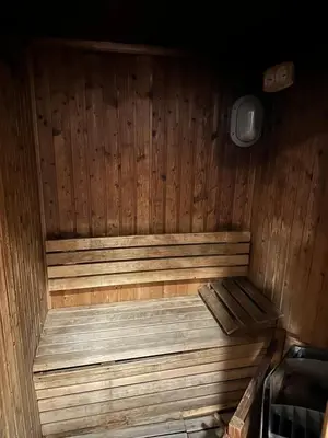 a wooden sauna with a wooden bench in a room at Prime Location Dubai Marina Apartment in Dubai
