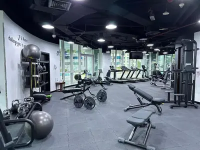 a gym with a bunch of exercise bikes and weights at Prime Location Dubai Marina Apartment in Dubai