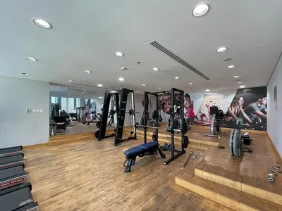 a gym with treadmills and machines in a room at GuestReady - Fantastic retreat with Palm views in Dubai