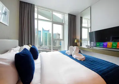 a hotel room with a large bed with a large window at Burj Khalifa & Canal View LuxeStudio in DAMACPrive in Dubai