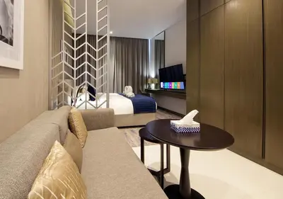 a hotel room with a couch and a bed at Burj Khalifa & Canal View LuxeStudio in DAMACPrive in Dubai
