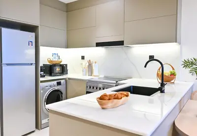 a kitchen with a sink and a dishwasher at Luxurious One Bed Near Dubai Mall with Burj and Canal View in Dubai