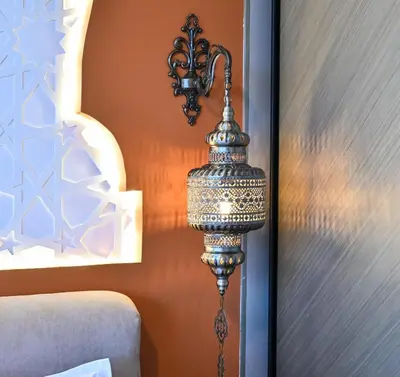 a lamp hanging on a wall next to a bed at Luxurious One Bed Near Dubai Mall with Burj and Canal View in Dubai