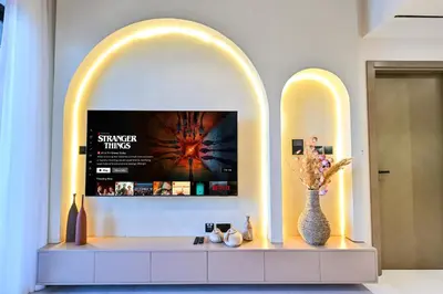 a room with two arches and a tv on a wall at Luxurious One Bed Near Dubai Mall with Burj and Canal View in Dubai