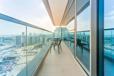 a balcony with tables and chairs on the floor of a building at Near Dubai Miracle Garden 1BR with Private Balcony, Orchid Residence, Al Barsha South by Deluxe Holiday Homes in Dubai