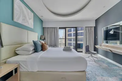 a bedroom with a large bed and a large window at GuestReady - Stylish home in Business Bay in Dubai