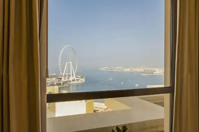 a view of a ferris wheel from a window at Short Stay Apartment Shams 1 Jumeirah Beach Residence 2 Bed Sleeps 6 - DVH HOLIDAY HOMES in Dubai