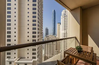 a balcony with a bench and a view of the city at Short Stay Apartment Shams 1 Jumeirah Beach Residence 2 Bed Sleeps 6 - DVH HOLIDAY HOMES in Dubai