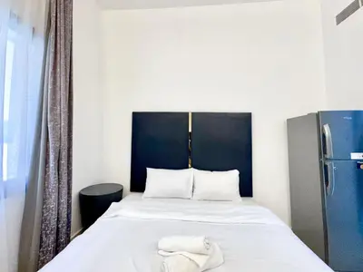 a bedroom with a bed with a towel on it at Al Manara Classic Deluxe Studio in Dubai