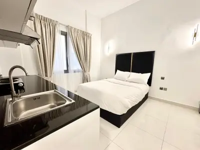 a small kitchen with a bed and a sink at Al Manara Classic Executive Studio in Dubai