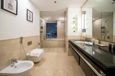 a bathroom with two sinks and a toilet and a shower at JW Marriott Marina By Luxe Living Collection - Wane By Somiya Infinity Pool in Dubai