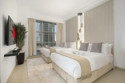 a hotel room with two beds and a window at Standpoint Tower by Luxe Living in Dubai
