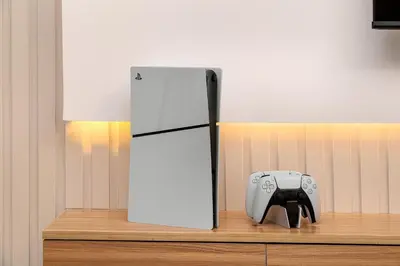 a video game controller sitting on a shelf next to a refrigerator at Standpoint Tower by Luxe Living in Dubai