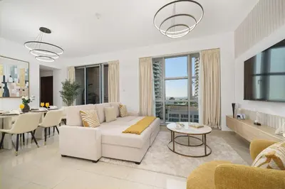 a living room with a white couch and a table at Standpoint Tower by Luxe Living in Dubai
