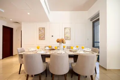 a dining room with a table and chairs at JBR Rimal By Luxe Living - Dubai Eye View in Dubai