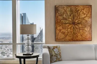 a living room with a couch and a table and a window at Shangri-La Apartments in Dubai