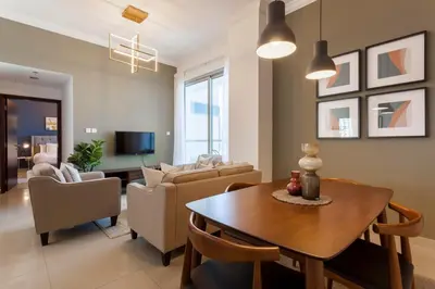 a living room with a table and a couch at GuestReady - Modern Apartment with Gorgeous Views in Dubai
