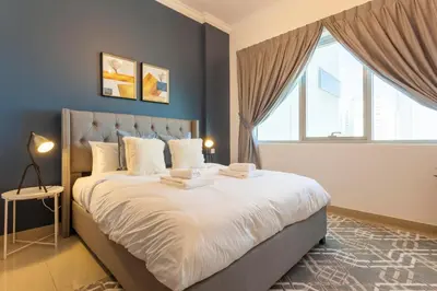 a bedroom with a large bed with a large window at GuestReady - Modern Apartment with Gorgeous Views in Dubai
