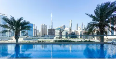 a large swimming pool with a city in the background at GuestReady - Modern Apartment with Gorgeous Views in Dubai