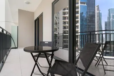 a balcony with a table and chairs on a balcony at Stylish 1BR In Zada Tower With Pool Views in Dubai