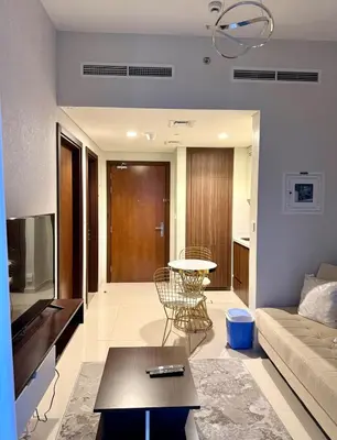a living room with a couch and a table at DAMAC Reva 5 mins Walk from Dubai mall in Dubai