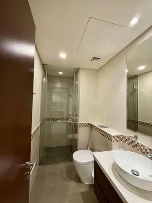a bathroom with a toilet and a shower and a sink at DAMAC Reva 5 mins Walk from Dubai mall in Dubai