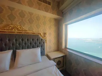 a bedroom with a bed and a large window at Artistic penthouse with amazing JBR Beach and sea view in Dubai