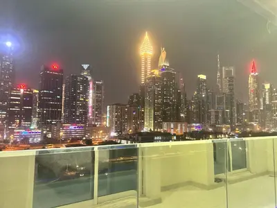 a view of a city skyline at night at Burj Views 2 BHK Apartment in Dubai