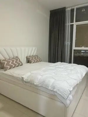 a white bed in a room with a window at Burj Views 2 BHK Apartment in Dubai