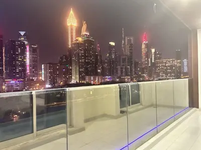 a view of a city skyline at night at Burj Views 2 BHK Apartment in Dubai