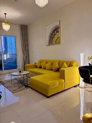 a yellow couch in a living room at Burj Views 2 BHK Apartment in Dubai