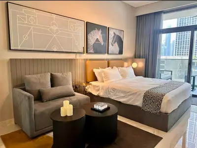 a bedroom with a bed and a couch at Mag 318 - 3 min walk to Dubai Mall - Luxury Studio - Pool & SLS View in Dubai