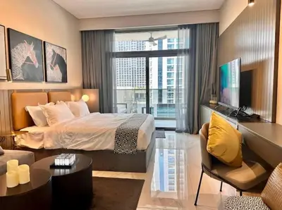 a bedroom with a large bed and a living room at Mag 318 - 3 min walk to Dubai Mall - Luxury Studio - Pool & SLS View in Dubai