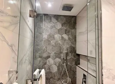 a bathroom with a shower with a glass door at Mag 318 - 3 min walk to Dubai Mall - Luxury Studio - Pool & SLS View in Dubai