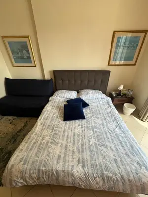 a bedroom with a large bed with a blue pillow at Marina Diamond in Dubai