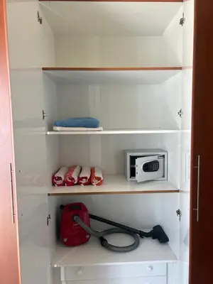 a kitchen with white shelves and a microwave at Marina Diamond in Dubai