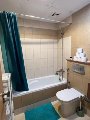 a bathroom with a toilet and a bath tub at Marina Diamond in Dubai