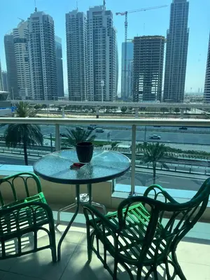 a table and chairs on a balcony with a view of a city at Marina Diamond in Dubai