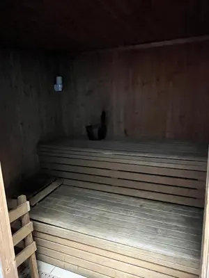 a sauna with a wooden floor and a wooden tub at Marina Diamond in Dubai