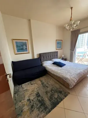 a bedroom with a bed and a couch at Marina Diamond in Dubai